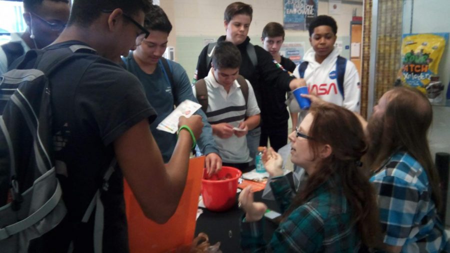Students gathered around a booth hosted by Virginia Beach Public Library, playing games to receive candy.