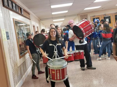 Faith Coley, sophomore and percussion caption, leading the drumline in a parade through the school. 