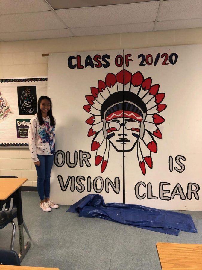 Katherine Louise Guevara in front of the senior sign that she designed. 