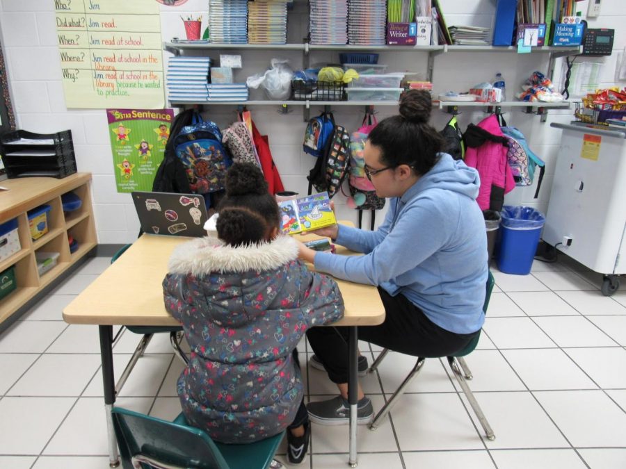 A member of the Interact Club reads with a young student at Diamond Spring Elementary School on January 25.