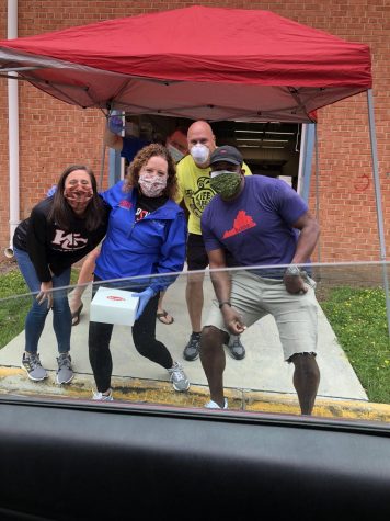 The administration serving lunch to teachers by way of a drive through constructed alongside the school.