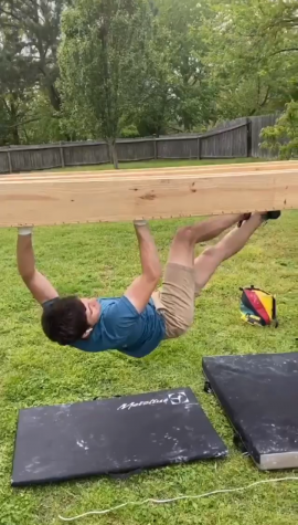 Andre Mas practicing on a crack climbing training frame that he made in his backyard.